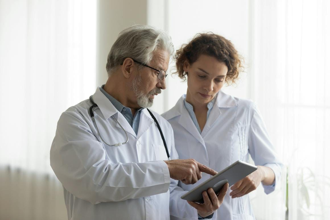Physician speaking to patient with a tablet