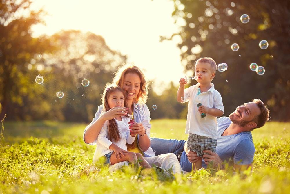 A family enjoying blowing soap bubbles