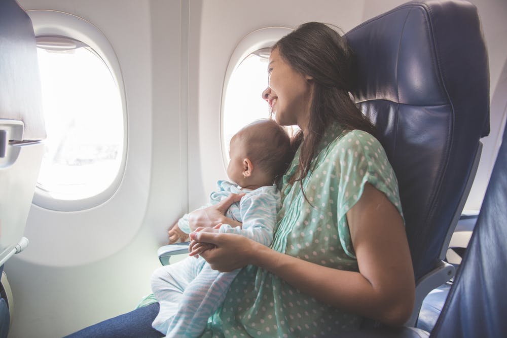 A woman with her baby in a plane