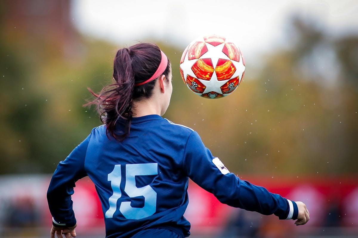 Teen girl playing with a soccer ball
