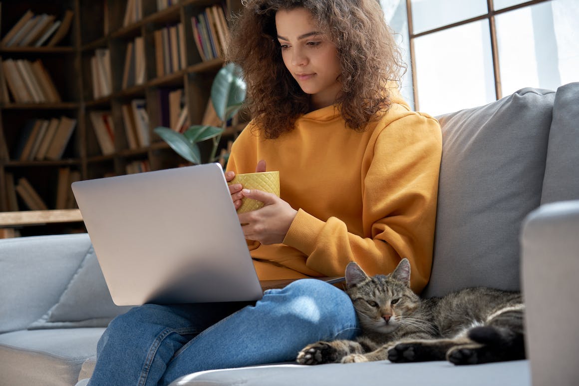 Woman on laptop with cat