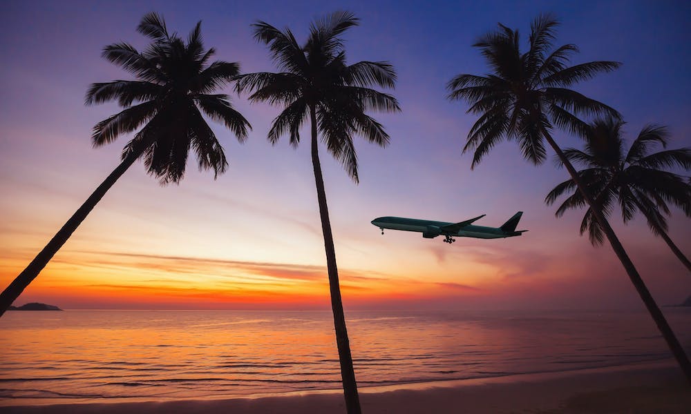 plane taking off in Hawaiian sunset