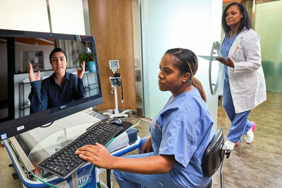 Two providers having a virtual visit with a patient