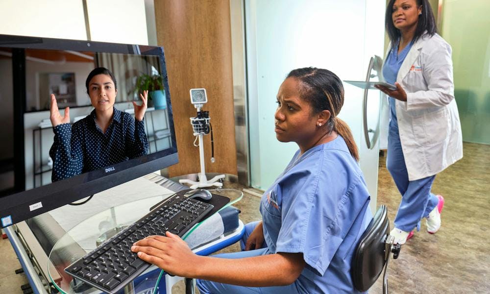 Two providers having a virtual visit with a patient