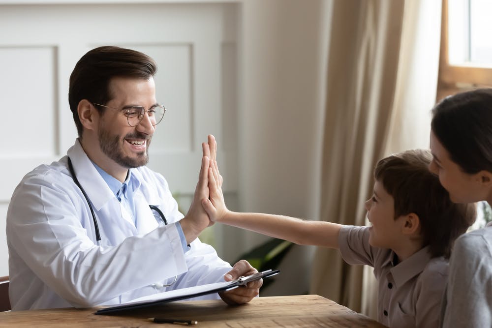 A doctor evaluating a pediatric patient