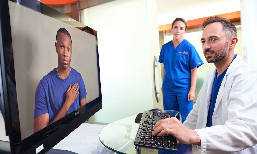 Provider and nurse meet virtually with a patient