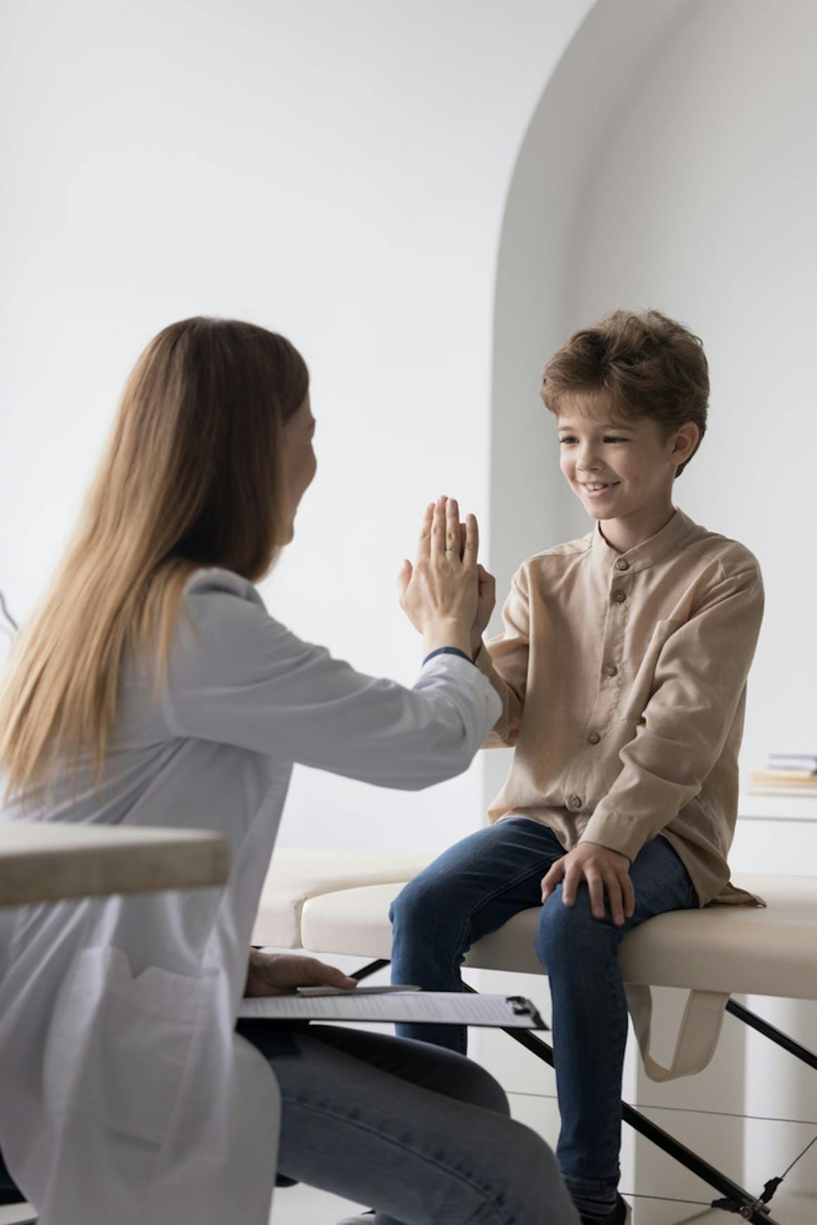 Child high five with doctor
